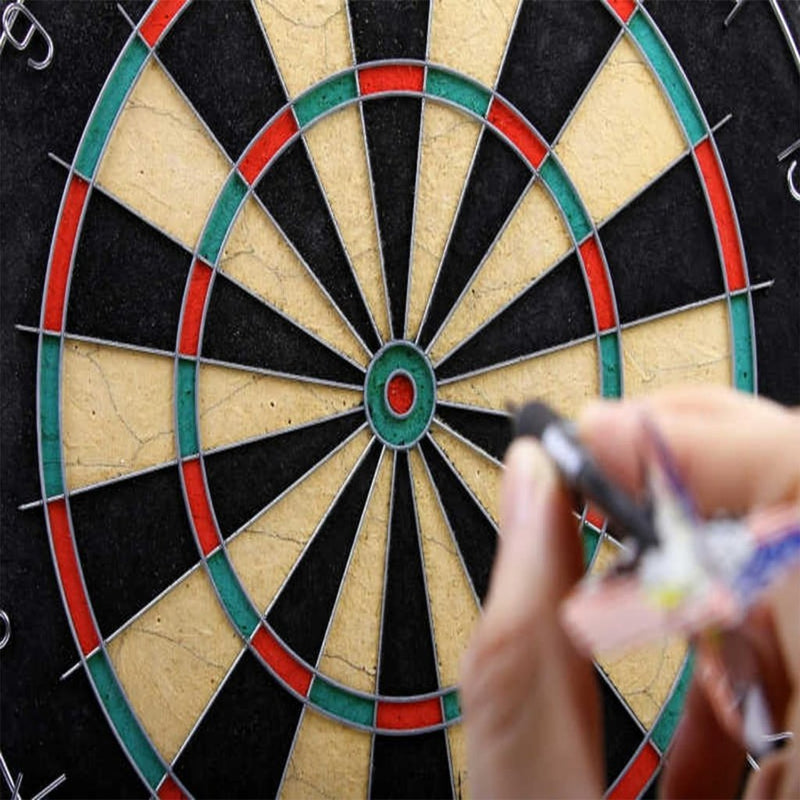 Laad afbeelding in Galerijviewer, Close-up van een hand die een pijl vasthoudt uit &quot;Perfecte dartpijlen voor beginners en enthousiaste spelers!&quot; 🎯 voor een dartbord met zijn levendige rode, groene, zwarte en beige delen.
