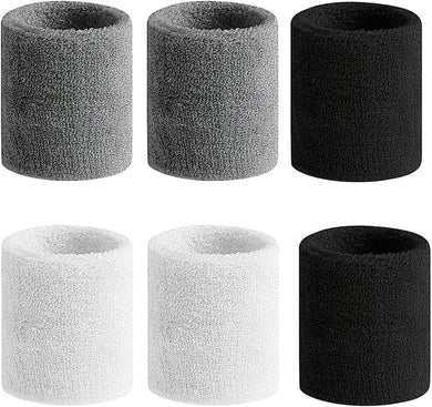 Zes Polsbandjes voor ultieme sportprestaties, ideaal als zweetbandjes, zijn verkrijgbaar in de kleuren grijs, zwart en wit, netjes gerangschikt in twee rijen van drie cilinders.