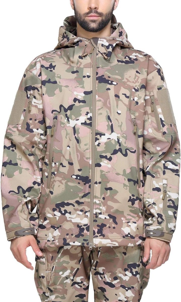 Laad afbeelding in Galerijviewer, Een persoon draagt een Camouflage tactische heren softshell jas gecombineerd met bijpassende broek, waardoor deze naadloos opgaat in de omgeving.
