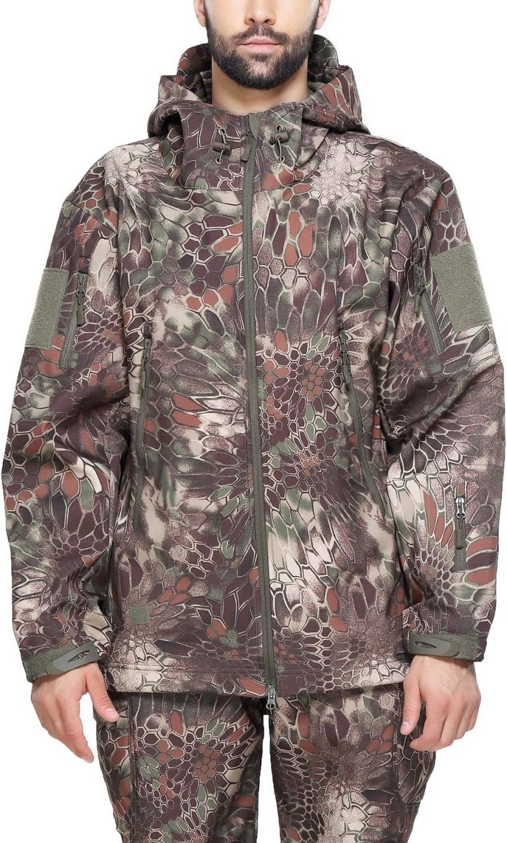 Laad afbeelding in Galerijviewer, Persoon draagt een Camouflage tactische heren softshell jas en broek, met een camouflagepatroon in de kleuren groen, bruin en beige.

