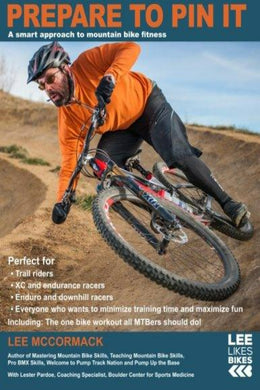 Een man in een oranje jas leunt behendig in een bocht terwijl hij mountainbiket op een onverharde weg. Deze tekst biedt essentiële tips voor mountainbikefitness en benadrukt Lee McCormack's 
