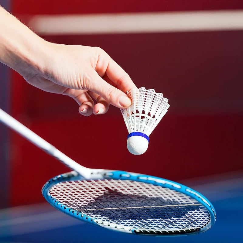 Laad afbeelding in Galerijviewer, Een hand houdt een LED verlichte badminton shuttle vast uit de set &quot;LED verlichte badminton shuttle set: maak van elke wedstrijd een feestje!&quot; boven een blauw frame racket, klaar voor een spannend spel in het donker.
