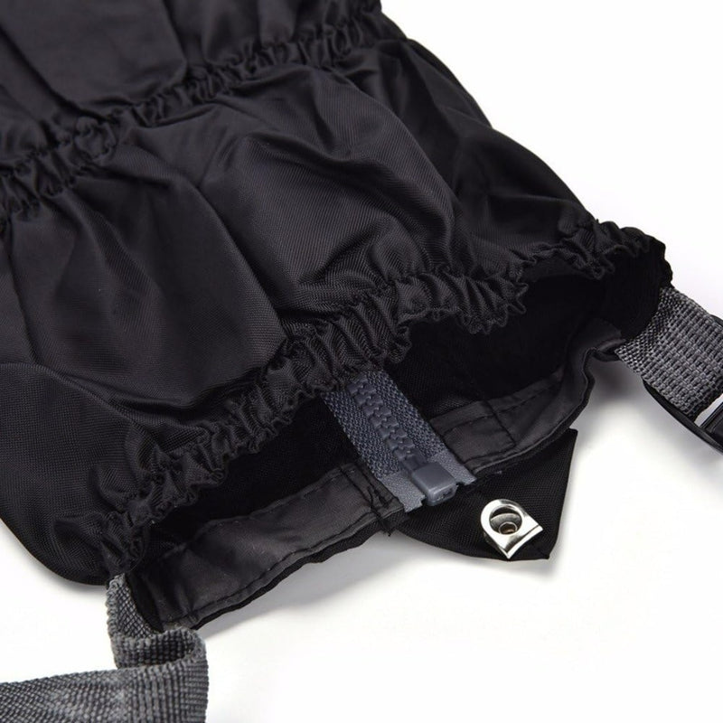 Laad afbeelding in Galerijviewer, Close-up van een zwarte tas met trekkoord en grijze riemen, ideaal voor buitenactiviteiten, voorzien van een metalen doorvoertule en een binnenrits. Product: Gaiters - de ultieme bescherming voor al je buitenactiviteiten.

